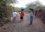 Art Carrying Water Arturo Garcia, a member of the San Diego chapter of Engineers Without Borders, carries green water vessel kn own as a cantarada on his shoulder. A woman of La Chiripa, in background, carries cantarada on her head