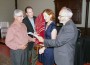 Emily Jennewein recites a prayer held by Rabbi Michael Berk after receiving Torah from former congregational presidents Ron Simon, left, and Jeff Silberman