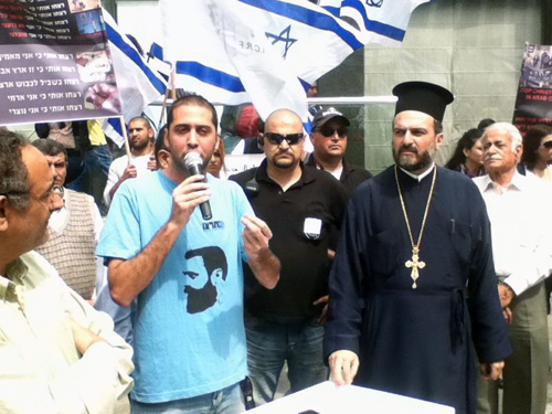 Father Gabriel Nadaf at right appears at rally calling for the West to protect Christians in Islamic countries