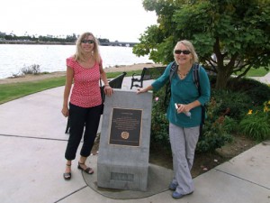 Teacher Dorothee Fetz and principal Doris Henningson pose at monument marking Louis Rose Point at the foot of Womble Road along the boat channel