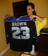 Cheyanne Sauter displays hockey shirt signed by LA Kings captain Dustin Brown