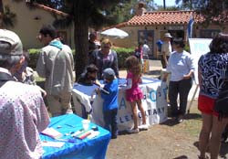 Sandi Masori and son Sky, 6, work the Kavod Public Charter School table