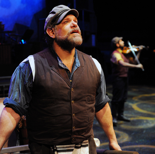 Tevye (Sam Zeller) sings as the Fiddler (Ernest Saucedo) plays. Photos: Ken Jacques