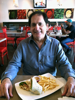 Enrique Lombrozo with Luna Grill's Chipotle Chicken Wrap