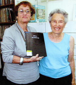 Librarian Bella Yakobovitch holds "Music Education in Israel," a master's thesis by Eileen Wingard, who stands beside her