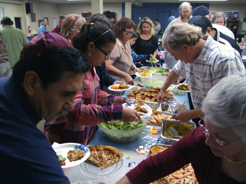 WE LIKE LATKES -- Congregants at Temple Beth Shalom go through the buffet line on Sunday, Dec. 1 (Photos: Donald H. Harrison)