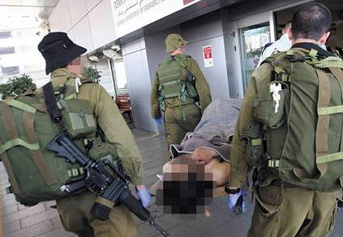 Syrian obscured being carried to Israel field hospital
