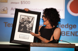 Jody Uttal examines Goodman Award picturing Rabbi Abraham Joshua Heschel and the Rev. Martin Luther King Jr.