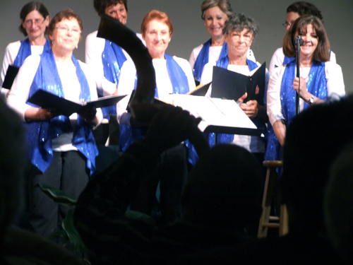 jose Duran foreground gives a blast on a shofar in appreciation of Beth Am Choir's performance