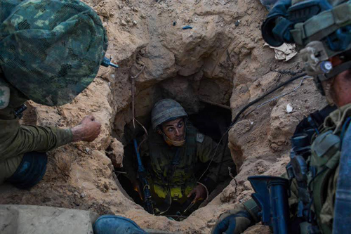 Members of an Israeli platoon examine a Hamas tunnel