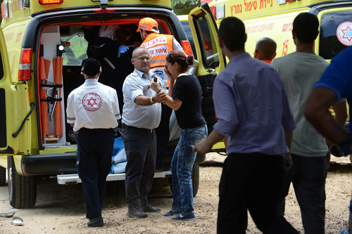 Relative reacts as 16 year old boy wounded by rocket is put in ambulance in Ashkelon