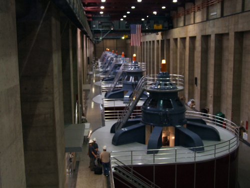 Size of Hoover Dam generators can be contrasted with the sizes of members of a work party in foreground
