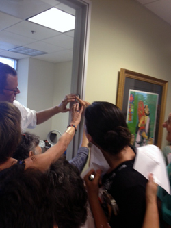 Rabbi Josh Burrows affixes mezuzah at JCoSD offices