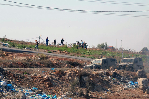 Palestinian rioters throwing rocks and firebombs across from Bet El on the old Route 60 (Photo: Hillel Maeir, Tazpit News Agency. )