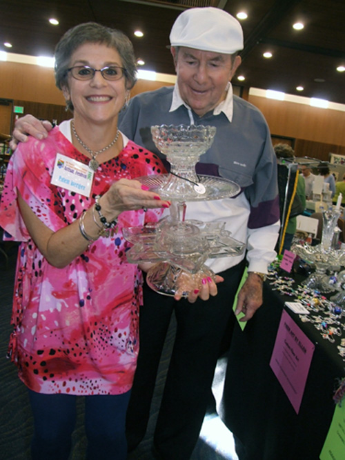 Glass artist Ellen Berger and father Lou Berger look over her triple decker creation with a Magen David base