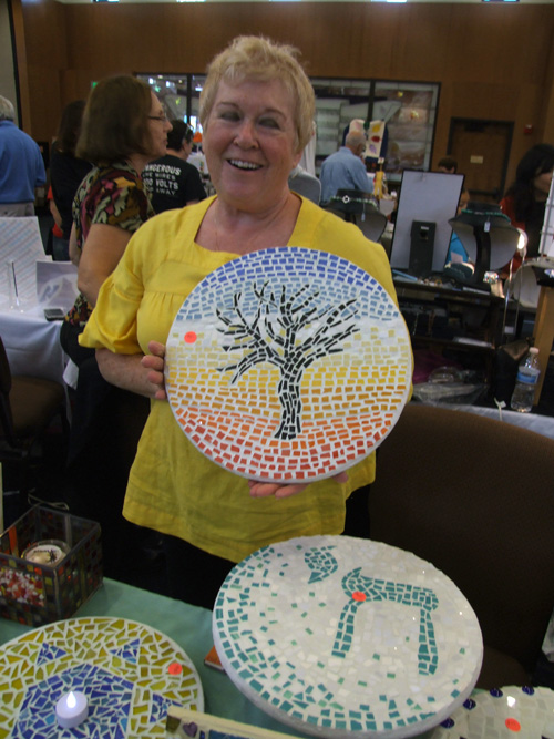 Lazy Susan by Sarit Segal pictures a Tree of Life. Below another one is decorated with a Chai.