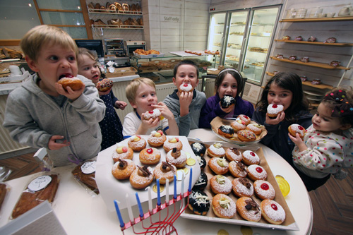 Young new Olim enjoying sufganiot (Photo: Yonit Schiller courtesy of Nefesh B’Nefesh)