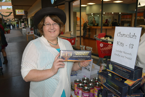 Shari Cohen displays a Chanukah kit for sale