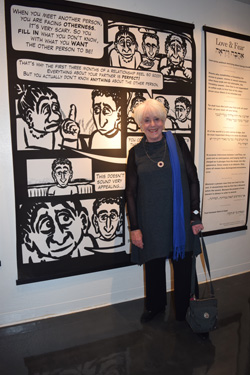 Joyce Axelrod, founder and curator of the short video and movie programs for the San Diego Jewish Film Festival, stands at Hanan Harchol's storyboard on love and fear.