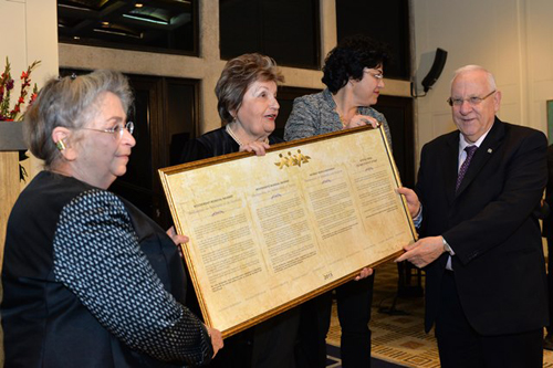Women of Na'amat present Israel's President Reuven Rivlin with a framed declaration of solidarity with Israel