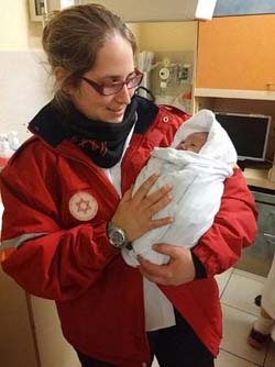 MDA Paramedic, Alumah Simon minutes after the birth of the newborn in Jerusalem. (Photo: Magen David Adom)