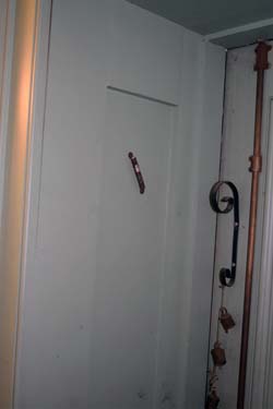 Mezuzah hangs on inside doorpost in shopping area of Robinson Rose Building