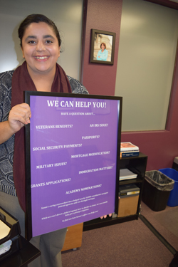 Armita Pedramrazi, staff assistant, displays board listing typical services provided by Susan Davis's district office.