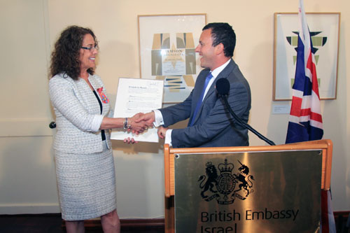 Ben Gurion University President Rivka Carmi accepts an honorary Commander of the British Empire award from U.K Ambassador Matthew Gould