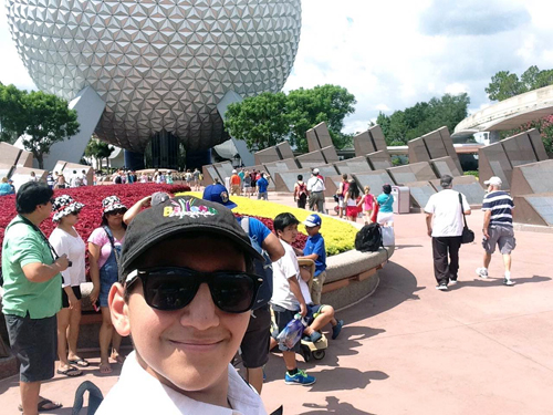 Grandson snaps a selfie at the Epcot theme building representing spaceship Earth