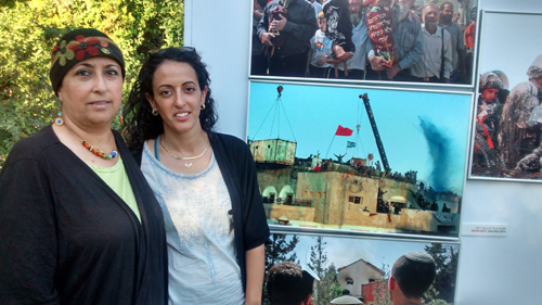 Orna and Hodaya Giat originally from Kfar Darom stand near photos of their Gush Katif community at a photography exhibition at an event marking 10 years to the Disengagement at the President's Residence in Jerusalem last week.  (Photo: Anav Silverman, Tazpit News Agency)