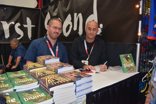 Boaz Lavie, left, and Asaf Hanuka sign copies of 'The Divine' at First Second booth