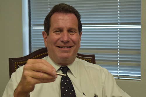 Dr. Ronald Goldberg displays tiny heart monitoring implant