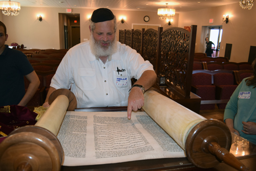 Rabbi Eilfort unrolls Holocuast Torah