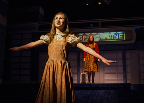 Katelyn Katz, foreground, portrays Violet as a young girl, and Hannah Corrigan plays her as a young woman.