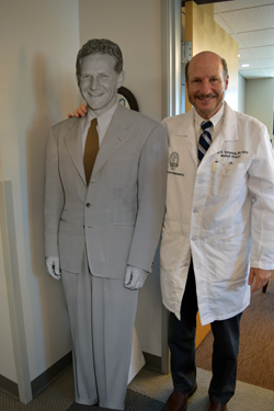 Dr. Paul Bernstein, right, with standup poster of Dr. Sidney Garfield