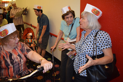 From left, Judy Burstain, Eleanor Lieb, and Nancy Harrison with Jelly Belly hats prepare to take factory tour