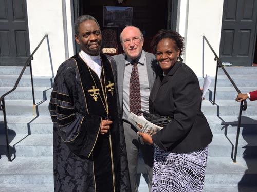 Rabbi Reuven Taff, center, enjoys fellowship at the Emanuel Church
