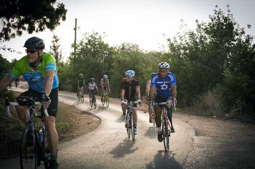 FIDF Cycling Tour leader Dany Saar of West Bloomfield, Mich., riding in front of wounded IDF veteran and FIDF Strides Program participant Col. Itzik Gabai. (Photo: Different View Photography)