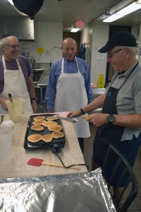 Alan Goldenberg and Bill Friedel observe Bill Sperling's pancake technique