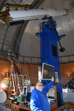 Alan Fisher, a volunteer guide at the Chabot Space and Science Center, poses with "Rachel."
