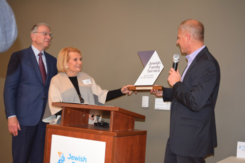 Michael Hopkins, CEO of Jewish Family Service, presents a plaque to lead donors Irwin and Joan Jacobs.