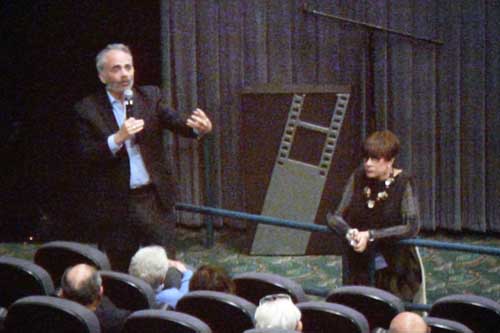 Rabbi Michael Berk takes a question about Torahs that are dropped following the screening of Encirclements. Emcee Judy Friedel,at right, listens
