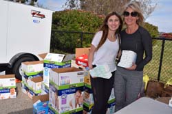 Gabi and Jennifer Levitt distribute diapers to needy military families. On other occasions, Gabi has helped children with art projects while their parents 'shopped.'