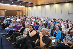 A portion of the crowd at Temple Emanu-El for Joellyn Zollman's deli lecture. Rabbi Devorah Marcus, front row, second from right, looks at the camera.
