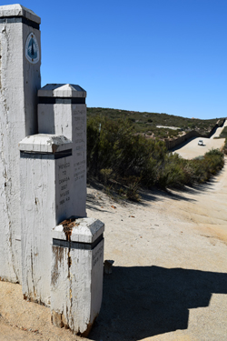 Pacific Crest Trail terminus at Mexican border. Border fence and Border Patrol car are in background