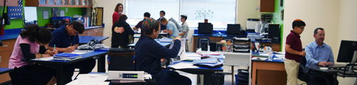 Soille San Diego High School students work independently in groups as science teach Matt Bessler, right, confers with a student