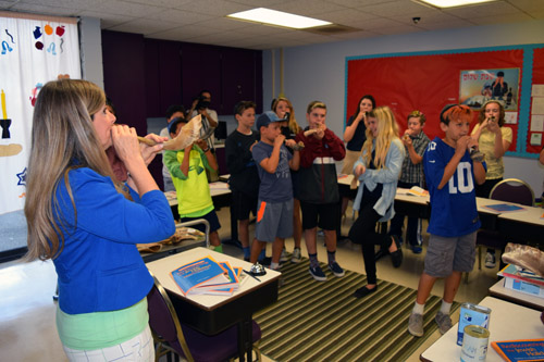 Olga Worm, left, teaches a class the notes of a shofar